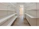 Walk-in pantry with generous shelving and flooring, providing ample storage space at 3440 Canyon Oak Way, Cumming, GA 30041