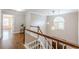 Bright, traditionally styled staircase with hardwood floors, white risers, and a decorative window with star pendant lights at 3440 Canyon Oak Way, Cumming, GA 30041