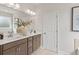 Bathroom featuring a double sink vanity, framed mirror with vanity lighting, and decorative vase at 92 Sheryl Way, Loganville, GA 30052