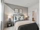 Stylish bedroom featuring two-tone paint, modern lamps, and window with natural light at 92 Sheryl Way, Loganville, GA 30052