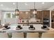 A kitchen with stainless steel appliances, pendant lighting and eat-in island at 92 Sheryl Way, Loganville, GA 30052