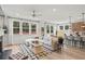 Living room with fireplace, large windows, and open-concept kitchen at 92 Sheryl Way, Loganville, GA 30052
