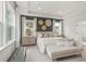 Well-lit main bedroom featuring a modern design, bedside tables, a bench, and lots of natural light at 92 Sheryl Way, Loganville, GA 30052