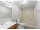 Well-lit bathroom features a single sink vanity, toilet, and shower-tub combination at 1214 Tyne Way, Stone Mountain, GA 30088