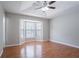 Primary bedroom boasts hardwood floors and a tray ceiling at 1214 Tyne Way, Stone Mountain, GA 30088
