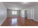 Spacious bedroom with hardwood floors, closet, and natural light from a large window at 1214 Tyne Way, Stone Mountain, GA 30088