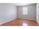 Spare bedroom with window, wood-look flooring, and neutral wall color at 1214 Tyne Way, Stone Mountain, GA 30088