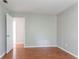 A spare bedroom with wood-look flooring, neutral walls, and ample space at 1214 Tyne Way, Stone Mountain, GA 30088
