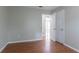 A spare bedroom with wood-look flooring, neutral walls, and an expansive closet at 1214 Tyne Way, Stone Mountain, GA 30088