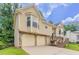 Side view of the home showcasing the two-car garage and inviting entrance at 1214 Tyne Way, Stone Mountain, GA 30088