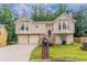 Charming two-story home with a well-maintained lawn and inviting front porch at 1214 Tyne Way, Stone Mountain, GA 30088