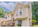 Exterior view of the house highlighting architectural details and lush landscaping at 1214 Tyne Way, Stone Mountain, GA 30088