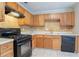Kitchen features wood cabinets, countertops, and black appliances at 1214 Tyne Way, Stone Mountain, GA 30088