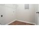Small laundry room area with vinyl floors and shelving at 1214 Tyne Way, Stone Mountain, GA 30088