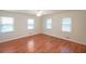 Bright bedroom with three windows and wood-look floors at 2055 Anderson Se Dr, Smyrna, GA 30080
