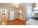 Cozy kitchen with light wood cabinetry, white appliances, and hardwood flooring at 2055 Anderson Se Dr, Smyrna, GA 30080