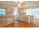 Well-maintained kitchen featuring white appliances, light cabinets, and hardwood flooring at 2055 Anderson Se Dr, Smyrna, GA 30080
