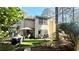 Backyard view that features synthetic grass, patio furniture, and mature trees at 4846 Twin Lakes Trl, Atlanta, GA 30360