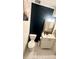 Modern bathroom features dark accent wall and gold framed mirror at 4846 Twin Lakes Trl, Atlanta, GA 30360