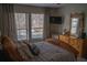 Bright bedroom with large windows, a comfortable bed, and a dresser, creating a serene and inviting atmosphere at 4846 Twin Lakes Trl, Atlanta, GA 30360