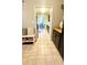 Bright hallway view with tile flooring, storage bench and entry to the kitchen at 4846 Twin Lakes Trl, Atlanta, GA 30360