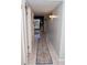 Inviting hallway featuring tiled floors, neutral walls, and stylish sconce lighting for a warm and welcoming ambiance at 4846 Twin Lakes Trl, Atlanta, GA 30360