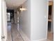 Inviting hallway featuring tiled floors, neutral walls, and stylish sconce lighting for a warm and welcoming ambiance at 4846 Twin Lakes Trl, Atlanta, GA 30360