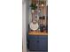 Charming kitchenette featuring dark blue cabinetry, wooden shelving, and decorative accents for a personalized touch at 4846 Twin Lakes Trl, Atlanta, GA 30360