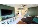 Living room featuring dark green walls, sectional sofa and open entryway at 4846 Twin Lakes Trl, Atlanta, GA 30360