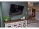 Stylish living room featuring a mounted TV, decorative plants, and a dining area in the background at 4846 Twin Lakes Trl, Atlanta, GA 30360