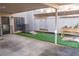 Inviting outdoor patio featuring artificial grass, cornhole, and string lights, perfect for entertaining and relaxation at 4846 Twin Lakes Trl, Atlanta, GA 30360