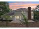 Backyard view showing the home's white exterior siding, brick chimney, and stone patio at 5276 Beechwood Ct, Marietta, GA 30068