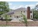 Backyard with white siding home, brick chimney, and stone patio at 5276 Beechwood Ct, Marietta, GA 30068