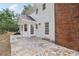 Charming backyard featuring a stone patio with white siding and brick chimney at 5276 Beechwood Ct, Marietta, GA 30068
