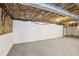 Unfinished basement with concrete block wall, exposed ceiling, and concrete floor provides a blank canvas at 5276 Beechwood Ct, Marietta, GA 30068
