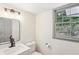Clean and bright bathroom with modern lighting, single vanity, and large window at 5276 Beechwood Ct, Marietta, GA 30068