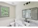 Bathroom featuring a vanity with marble countertop, and updated fixtures plus a glass shower and window at 5276 Beechwood Ct, Marietta, GA 30068