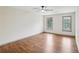 Large bedroom with hardwood floors and two windows with a view of the backyard at 5276 Beechwood Ct, Marietta, GA 30068