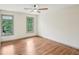 Bedroom with hardwood floors, two windows with a view of the backyard and natural light at 5276 Beechwood Ct, Marietta, GA 30068
