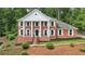 Stately brick home featuring a columned facade, manicured landscaping, and a welcoming front entrance at 5276 Beechwood Ct, Marietta, GA 30068