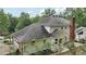 The rear exterior shows the home's design and dark roof amidst a lush, green backdrop at 5276 Beechwood Ct, Marietta, GA 30068