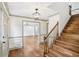 Inviting foyer featuring hardwood floors, staircase, and a glimpse into the adjacent living spaces at 5276 Beechwood Ct, Marietta, GA 30068