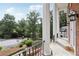 Inviting front porch with stately columns, stone flooring, and elegant outdoor lighting fixtures at 5276 Beechwood Ct, Marietta, GA 30068
