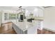 Well-lit kitchen boasts granite counters, island, and modern appliances at 5276 Beechwood Ct, Marietta, GA 30068