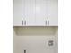 Laundry area featuring white cabinets and modern fixtures for convenience at 5276 Beechwood Ct, Marietta, GA 30068