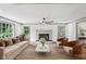 Bright living room boasts a fireplace, ceiling fan, and abundant natural light at 5276 Beechwood Ct, Marietta, GA 30068