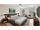 Well-lit main bedroom featuring a king-size bed, ceiling fan, and sitting area at 5276 Beechwood Ct, Marietta, GA 30068