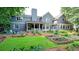 Spacious backyard with a well-manicured lawn, garden beds, and a covered patio perfect for outdoor entertainment at 1178 Chambord Ne Way, Brookhaven, GA 30319