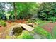 A charming backyard features a pond with a small bridge, perfect for relaxation and enjoyment at 1178 Chambord Ne Way, Brookhaven, GA 30319