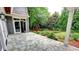 A stone backyard patio offers a tranquil transition from indoor living to a lush green outdoor setting at 1178 Chambord Ne Way, Brookhaven, GA 30319
